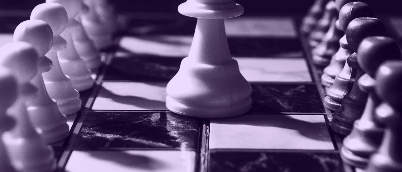 Rozehraná strategická hra s dřevěnými figurkami a žetony na stole
